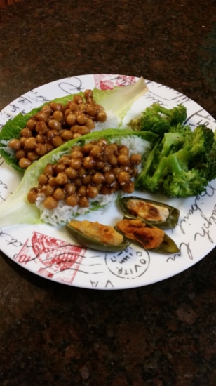 Lettuce wrapped Kung Pao chickpeas over a bed of rice, with a side of steamed broccoli and baked jalapeño peppers stuffed with hummus.