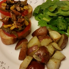 My version of bruschetta - slice of French bread, topped with a tomatoe slice, grilled veggies, corn, and beans. Served with a side of spinach and roasted potatoes.